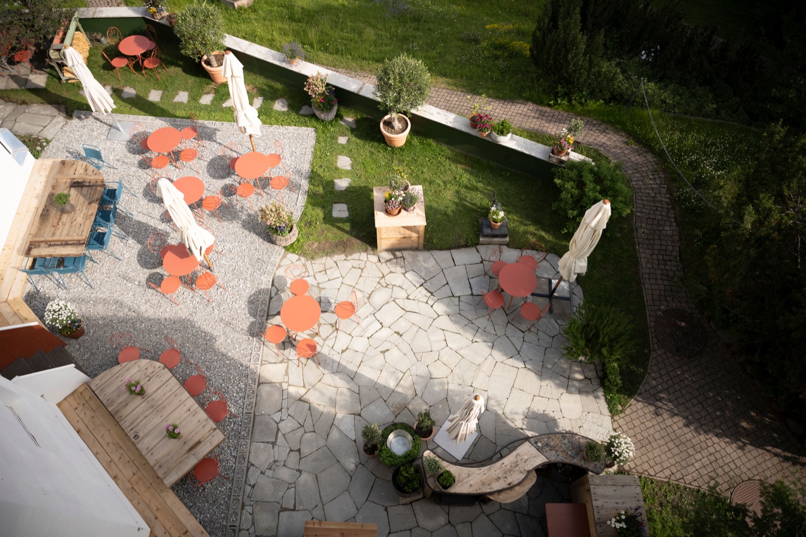 The villa's summer garden terrace, tables set above the lake