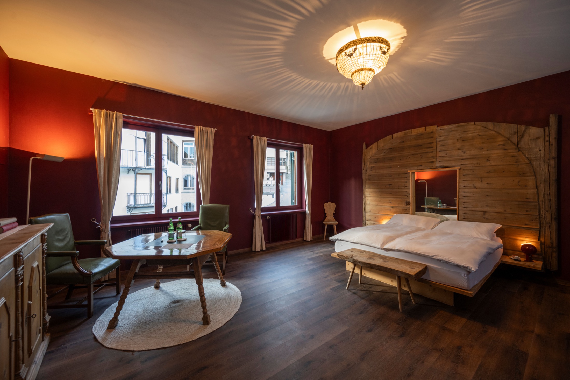 La Stalla junior suite at Villa Beaulieu — historic Engadin barn door and town view